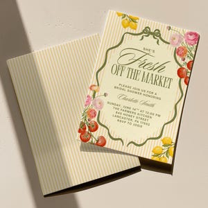 May include: A bridal shower invitation with a vintage design. The invitation features the text "She's Fresh Off The Market" with floral and fruit illustrations. The background is a light cream color with vertical stripes.
