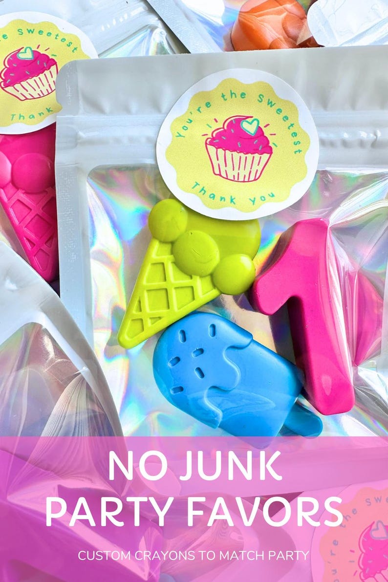 May include: A clear holographic pouch containing three shaped crayons: a lime green ice cream cone, a bright blue popsicle, and a hot pink number one. A round sticker on the front features a pink cupcake illustration and the text You're the sweetest Thank you.