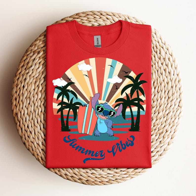 May include: Red t-shirt with a cartoon character wearing sunglasses and holding a surfboard, set against a beach scene with palm trees and a sunset. The text "Summer Vibes" is written in blue script.