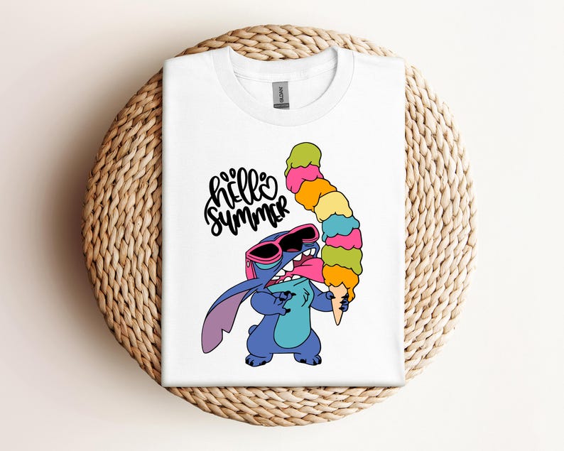 May include: White t-shirt featuring a cartoon character wearing sunglasses and holding a large, colorful ice cream cone. The shirt has the words "hello summer" in a playful font. The design is centered on the shirt.