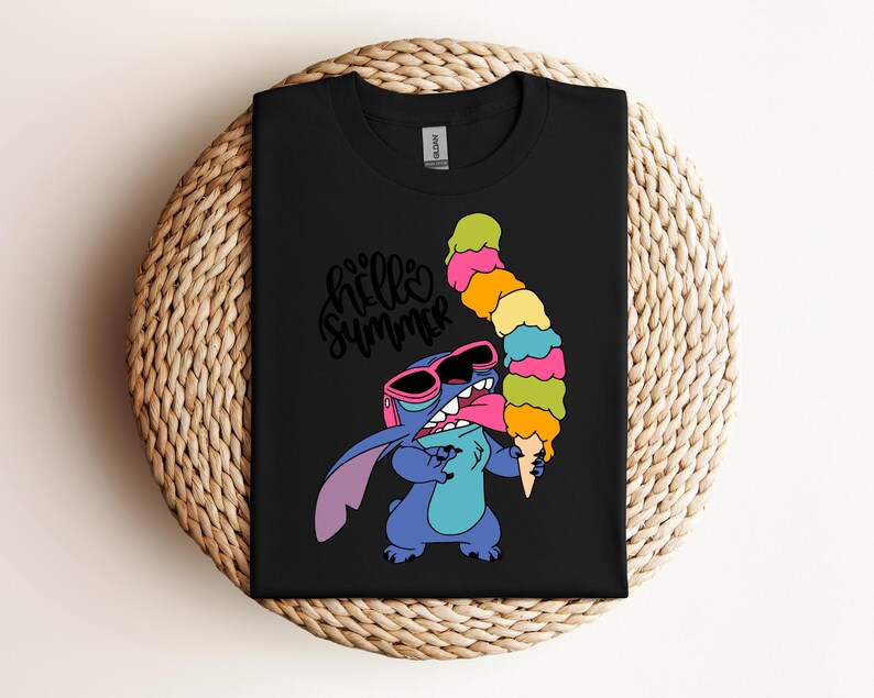 May include: Black t-shirt featuring a cartoon character wearing sunglasses and holding a colorful ice cream cone. The shirt has the words "hello summer" in a cursive font. The character is blue with pink accents.