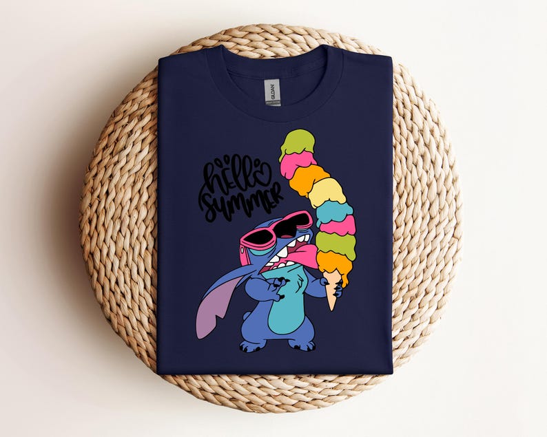 May include: Navy blue t-shirt featuring a cartoon character holding a large, colorful ice cream cone. The character wears sunglasses and the shirt has the text "hello summer" in a cursive font.