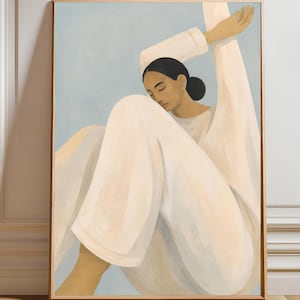 May include: A framed wall art print featuring a stylized painting of a person with dark hair pulled back, wearing a long-sleeved white garment. The figure is seated with one arm raised, set against a soft, muted light blue background.