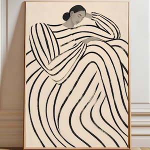 May include: A framed wall art print featuring a stylized illustration of a person with dark hair pulled back, wearing a long-sleeved garment with bold black vertical stripes against a cream background, seated in a relaxed, resting pose.