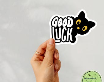 Good Luck Cat Sticker | Black Cat Peeking Around Text with Yellow Eyes