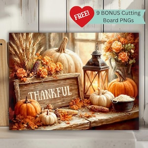 May include: A fall-themed still life featuring pumpkins, gourds, and autumn foliage. A wooden sign with the word "THANKFUL" is displayed. A lit lantern and a vase of orange roses add warmth to the scene. The image includes the text "FREE! 9 BONUS Cutting Board PNGs".