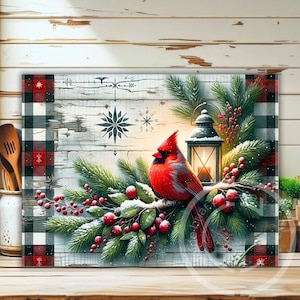 May include: A decorative rectangular artwork featuring a vibrant red cardinal perched on a snow-dusted branch with red berries and evergreen boughs. A lit lantern and snowflake designs are also present. The artwork has a buffalo plaid border.