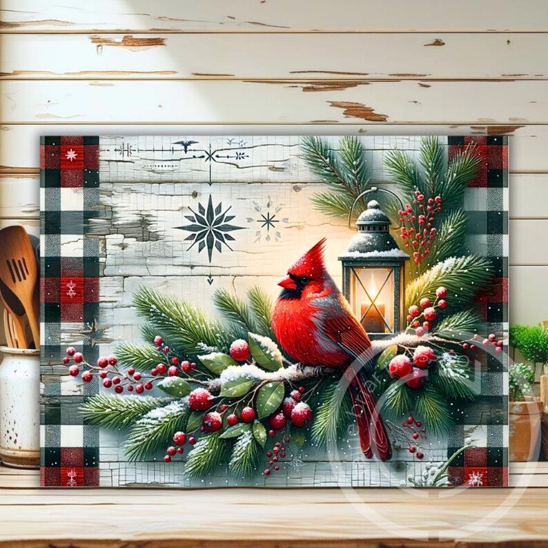 May include: A decorative rectangular artwork featuring a vibrant red cardinal perched on a snow-dusted branch with red berries and evergreen boughs. A lit lantern and snowflake designs are also present. The artwork has a buffalo plaid border.