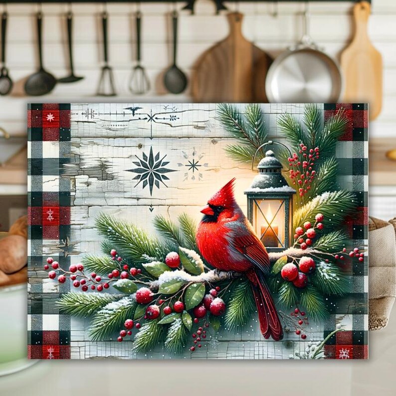 May include: A decorative rectangular wall art piece featuring a vibrant red cardinal perched on a snow-covered branch with red berries and evergreen boughs. A lantern with a lit candle sits nearby. The background is a rustic wooden panel with snowflake designs and a buffalo plaid border.