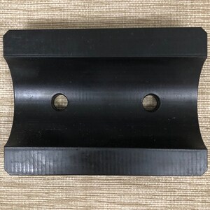 May include: Black plastic pipe clamp with two holes.