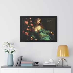 May include: Framed art print featuring a woman in a teal gown with gold accents, reclining near pink roses. The artwork has a dark background and the text "VIXIS" in gold. The print is in a black frame.