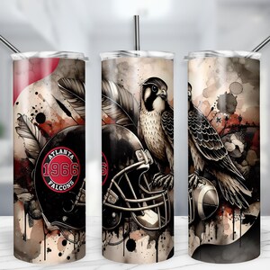 May include: A set of three stainless steel tumblers with black straws. Each tumbler features a watercolor design with an Atlanta Falcons theme. The design includes a football helmet, a falcon, and the text "ATLANTA 1966 FALCONS."