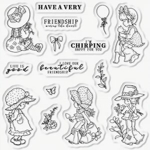 May include: A set of clear rubber stamps featuring illustrations of girls wearing hats and dresses, along with various phrases like "Have a Very Friendship", "I'm Chirping Happy for You", and "Life is Good".