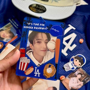 May include: A blue acrylic baseball-themed charm with the text "IT'S TIME FOR DODGER BASEBALL!" and a photo of a person. The charm includes images of a baseball, bat, glove, and a Los Angeles Dodgers baseball cap.