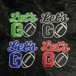 May include: Four embroidered patches featuring the text Let's GO with a football graphic. The patches come in four distinct color variations: green, black, blue, and red. Each patch has a black border and white stitching details on the football.