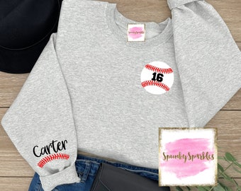 May include: Gray sweatshirt with a baseball graphic on the front and the name "Carter" on one sleeve. The baseball has the number "16" on it.