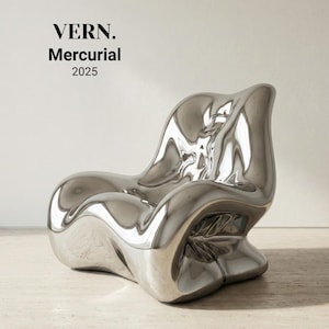 May include: A modern, sculptural chair with a polished, reflective silver finish. The chair has an organic, flowing form and is labeled "VERN. Mercurial 2025". The design features a low seat and a curved back, suitable for interior design.