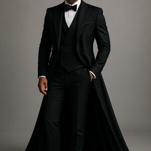May include: A black formal suit with a long coat, white shirt, and black bow tie. The three-piece suit includes a waistcoat and tailored trousers. The man is wearing black dress shoes. The background is a plain grey.