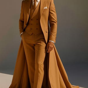 May include: A tan three-piece suit, comprising a jacket, waistcoat, and trousers. The jacket has a traditional lapel and a pocket square. The suit is worn with a white shirt and a matching tie. The trousers are straight-legged, and the suit has a long cape.
