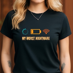 May include: Black t-shirt with the phrase "MY WORST NIGHTMARE" in orange text. The shirt features three orange and teal icons: a loading symbol, a battery, and a wifi symbol. The shirt is a crew neck.