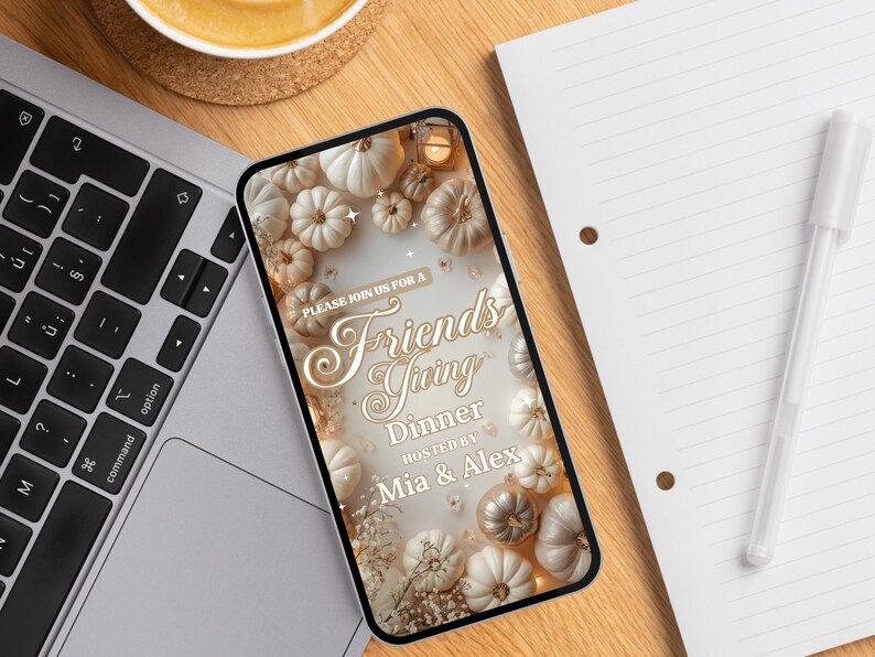 May include: A smartphone displays a Friendsgiving dinner invitation. The design features white and gold pumpkins, floral accents, and the text "Please join us for a Friendsgiving Dinner hosted by Mia & Alex."