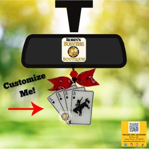 May include: Car rearview mirror accessory with a red bandana bow and playing cards. The cards feature the Ace of Spades, Hearts, Diamonds, and Clubs. The text "Customize Me!" is visible.