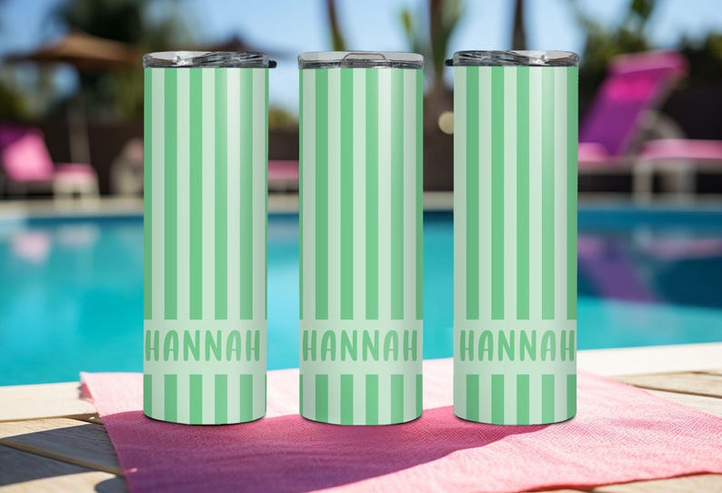May include: Three cylindrical tumblers with lids, each featuring a vertical striped pattern in alternating shades of light green and mint. The name HANNAH is printed in a bold, sans-serif font across the lower section of each tumbler.