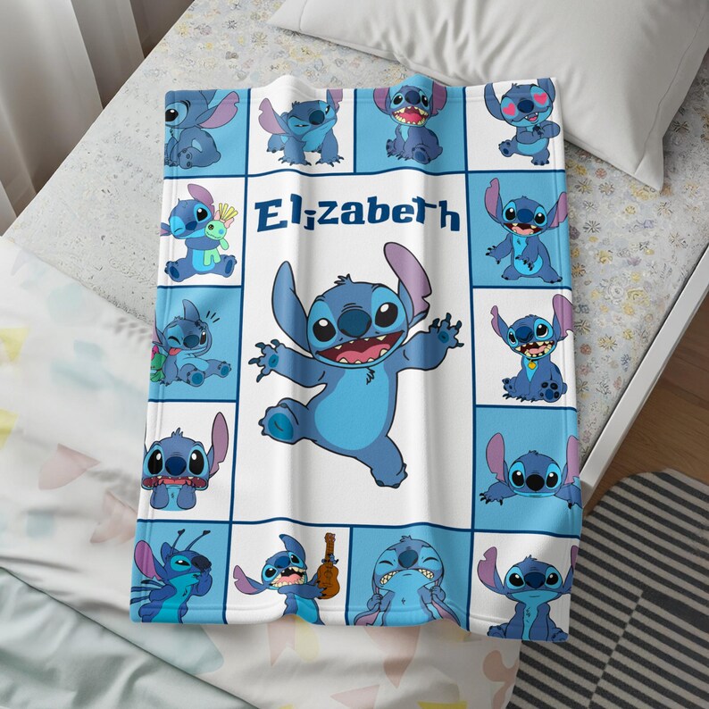 May include: A blue and white blanket featuring the character Stitch from Lilo & Stitch. The blanket has a grid pattern with various Stitch poses and the name "Elizabeth" in the center. The blanket is made of a soft material.
