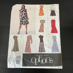 May include: A Vogue Easy Options sewing pattern envelope, number 2654, featuring illustrations of various two-piece outfits including blouses and skirts in different colors and patterns, with a photograph of a black and white floral dress.