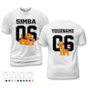 May include: White t-shirts featuring a Simba design. The front of the shirt has the word "SIMBA" above the number "06" with a cartoon lion and a small animal. The back of the shirt has the word "YOURNAME" above the number "06" with a cartoon lion.