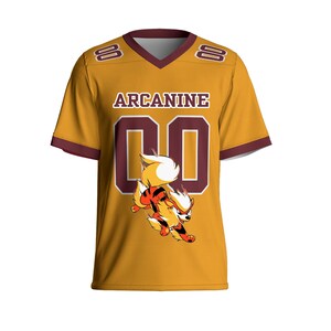 May include: Mustard yellow football jersey with maroon accents and the name "Arcanine" across the chest. The jersey features the number "00" in maroon and a cartoon image of Arcanine. The sleeves and collar are trimmed in maroon.