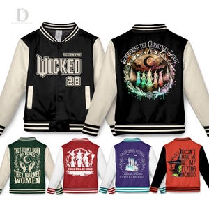 May include: Several letterman jackets with different designs. One is black with "WICKED 28" on the front. Other jackets display witch-themed graphics and phrases such as "Summoning the Christmas Spirit!" and "Girls Will Be Girls."