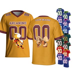 May include: Mustard yellow football jersey with maroon accents, featuring the name "ARCANINE" and the number "00". A cartoon Arcanine character is on the front. Additional jerseys in various colors are displayed.