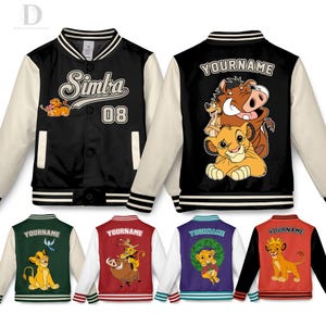 May include: Black and cream-colored varsity jacket featuring the word "Simba" and the number "08" on the front. The back of the jacket has a cartoon image of Simba, Timon, and Pumbaa. Additional jackets in green, red, purple, and orange are also shown.