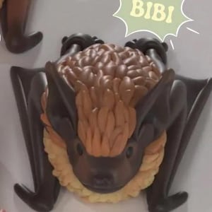 May include: A collection of bat figurines in various shades of brown, tan, and pink. Each bat has a unique design and is labeled with a name: Indy, Ali, Bibi, Otis, and Peri. The image also includes text indicating the product is a 3D rendered image.