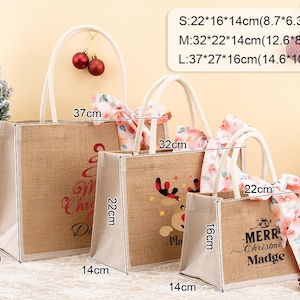 May include: Three jute tote bags of varying sizes, with white handles and floral ribbon accents. The largest bag is 14.6 inches wide, 10.6 inches tall, and 6.3 inches deep. Each bag features a Christmas-themed design and text.