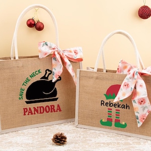 May include: Two burlap tote bags with white handles and floral bows. One bag has a black turkey graphic and the name "Pandora" in red. The other bag features an elf graphic and the name "Rebekah".