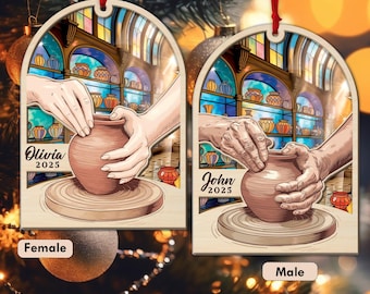 May include: Wooden Christmas ornament featuring a pottery scene with hands shaping a clay pot. The ornament has a stained glass window design in the background. The names "Olivia" and "John" are written on the ornaments, along with the year "2025".