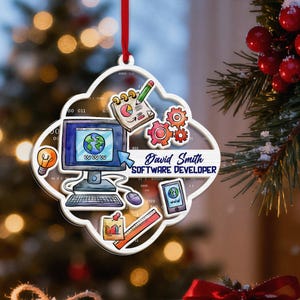 May include: A clear, cloud-shaped Christmas ornament with a red ribbon. The ornament features a computer, gears, and a tablet, with the text "David Smith SOFTWARE DEVELOPER". The design includes a lightbulb, a notepad, and a ruler.