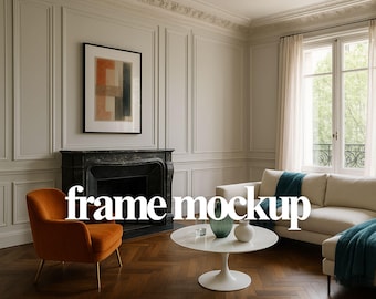 May include: A stylish living room with a black framed artwork above a black fireplace. An orange armchair, a white sofa, and a white round table with vases are visible. The text "frame mockup" is overlaid on the image. The room has a parquet floor.