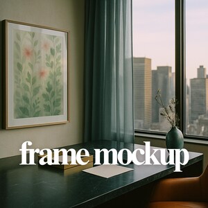 May include: A framed botanical watercolour print featuring green leaves and pink flowers hangs on a wall. The image is in a room with a desk, a window overlooking a city skyline, and the text "frame mockup".
