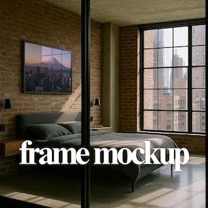May include: Bedroom interior with a framed landscape art piece above a bed with gray bedding. The room features a brick wall, large windows, and the text "frame mockup" in white.