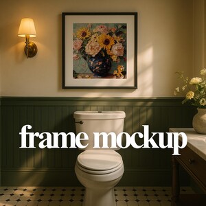 May include: A framed floral print featuring sunflowers and other flowers in a blue vase hangs above a white toilet in a bathroom. The words "frame mockup" are displayed in white text across the image.