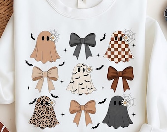May include: White sweatshirt featuring a pattern of cartoon ghosts in various colors and patterns, including brown, checkered, and leopard print. Each ghost has a daisy and spiderweb detail. Black bows and bats are also featured.