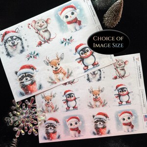 May include: Two sheets of stickers featuring illustrations of winter animals including a kitten, mouse, husky, raccoon, deer, and penguin, all wearing red Santa hats and scarves. Some animals hold candy canes or skate on ice against snowy backgrounds.