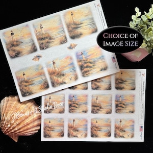 May include: Sheets of nail art stickers featuring lighthouse and beach scenes. The stickers have a watercolor effect with warm sunset colors. The text "CHOICE OF IMAGE SIZE" is visible. The brand name "J Bonus Art Studio Deco" is also visible.