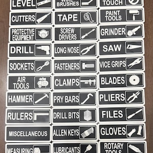 May include: A collection of black and white tool labels, each with a tool name and a corresponding graphic. The labels include "Level," "Cutters," "Protective Equipment," "Drill," "Sockets," "Air Tools," "Hammer," "Rulers," "Miscellaneous," and "Measuring."
