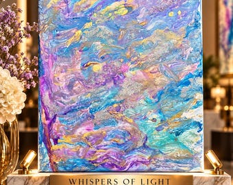 May include: A rectangular canvas painting featuring swirling abstract patterns in shades of blue, purple, pink, and gold with silver glitter accents. A gold plaque on the marble base reads: WHISPERS OF LIGHT, FARIPALETTE ART STUDIO, 11 x 14 INCHES.