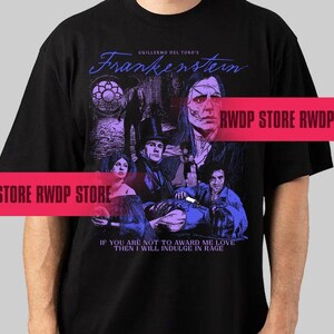 May include: Black t-shirt featuring a graphic from Guillermo del Toro's "Frankenstein." The design includes the title in blue script, a collage of characters, and the quote "If you are not to award me love then I will indulge in rage."