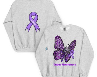 May include: Light gray sweatshirt featuring a purple ribbon with the word "Lupus" on the back. The front displays a cartoon butterfly with purple wings and the text "Lupus Awareness". A small blue ribbon is on the sleeve.